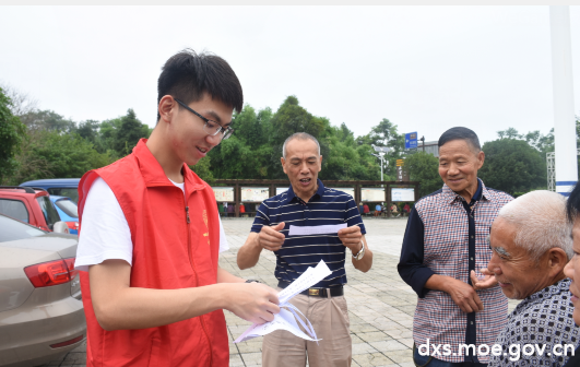 图为团队成员向社区居民发放安全资料
